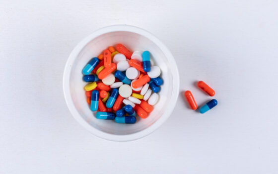 Buy Top view pills in bowl on white background. horizontal online